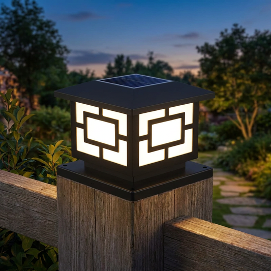 Solar LED post cap light on a fence pillar at dusk