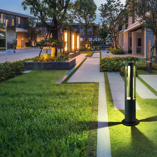 LED garden bollard lawn light glowing at dusk